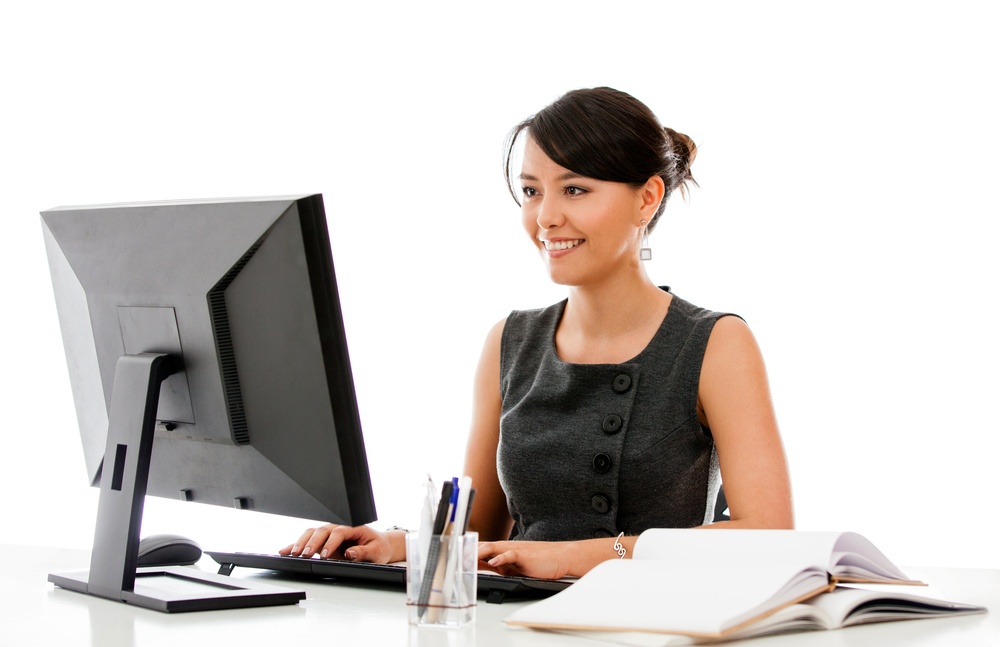 Businesswoman at the office working on a computer - isolated.jpeg