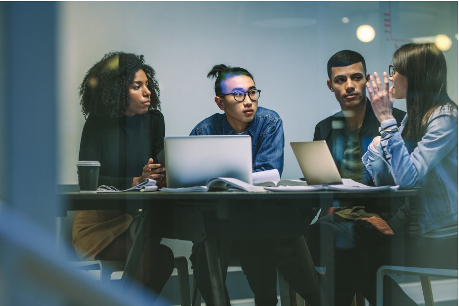 group-of-young-students-working-on-an-assignment-picture-id1071467916