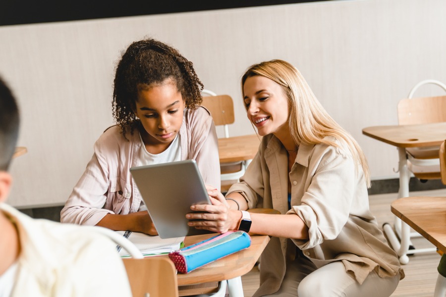 young-teacher-tutor-helping-africanamerican-girl-students-pupils-picture-id1338740162